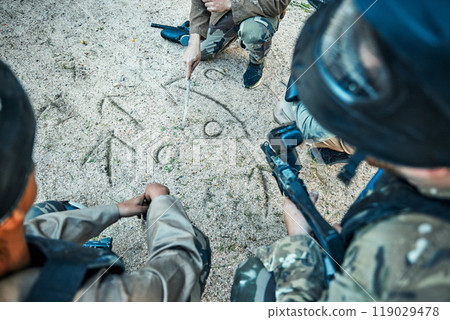 Paintball, battlefield and team building with game plan, mission and strategy drawing in sand with soldier group. War, gun and plan attack, people outdoor and military tactics and army with teamwork 119029478
