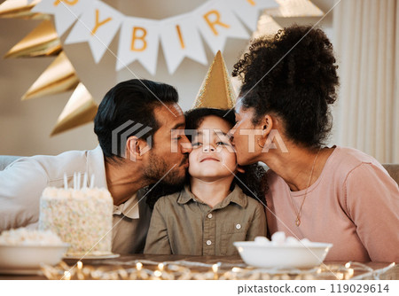Father, mother and child at birthday party, kiss and happy with celebration, care and bonding in family house. Dad, mom and young kid with event, excited face and love together at table in apartment 119029614