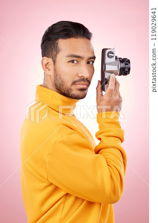 Portrait, man and retro camera for creative photography or taking a picture for art, travel or record of a memory. Serious, creative photographer and shooting on vintage film technology in studio 119029641