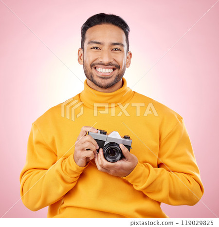 Portrait, photographer with a camera and smile for photography, taking picture for art or travel as cameraman with a happy memory. Creative man on studio background, shooting on retro or vintage film 119029825