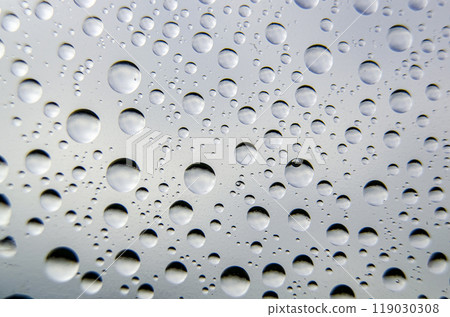 Top view of rainwater droplets on clear plastic. Fresh rain concept 119030308