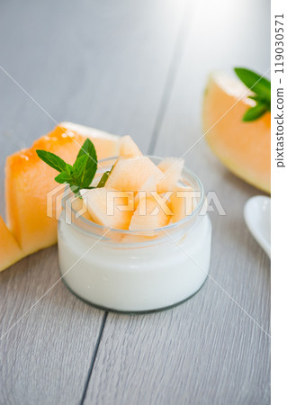 sweet homemade yogurt in a jar with pieces of ripe melon sweet homemade yogurt in a jar with pieces of ripe melon 119030571