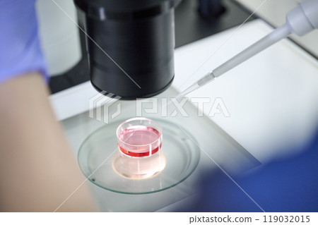 Embryologist using a microscope 119032015
