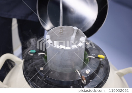 An experimenter managing samples in a liquid nitrogen tank 119032061