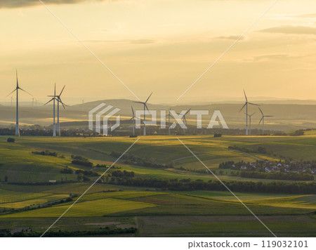 Wind Turbines in a Beautiful Landscape and Sunset Sky. Alternative electricity, sustainable resources, Renewable energy 119032101