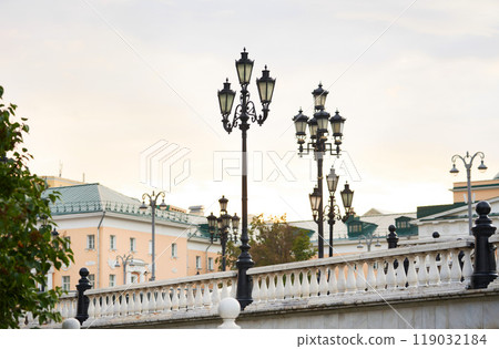 Beautiful white marble balusters and lamp posts on Manezhnaya Square in Moscow. Cityscape. Beautiful white marble balusters and lamp posts on Manezhnaya Square in Moscow. Cityscape. 119032184