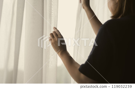 A woman by the window 119032239