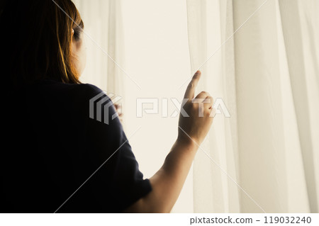 A woman by the window 119032240