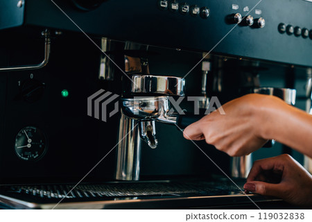 Coffee machine preparing fresh tasty coffee in cafe. Step by step tips of coffee making process. Close up of machine hand holding handle showcasing professional brewing. Coffee machine preparing fresh tasty coffee in cafe. Step by step tips of coffee making process. Close up of machine hand holding handle showcasing professional brewing. 119032838