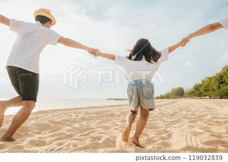 Happy Asian parents with their daughters enjoying playful at beach. Little girls with their mother and father holding hand of child running and pretending on sand. Positive family outdoor activity Happy Asian parents with their daughters enjoying playful at beach. Little girls with their mother and father holding hand of child running and pretending on sand. Positive family outdoor activity 119032839