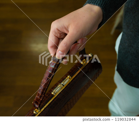 Woman holding a handbag Woman holding a handbag 119032844