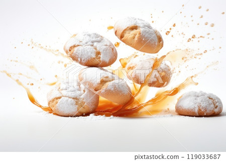 Exploding powdered sugar cookies with caramel splash on white background 119033687