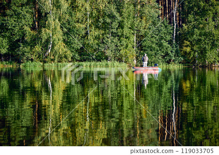 Fishing in a Boat on Calm Forest Lake Fishing in a Boat on Calm Forest Lake 119033705