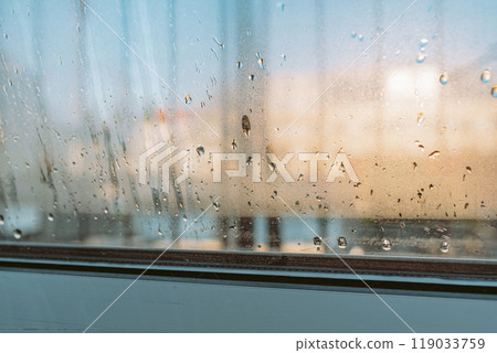 water droplets running on a double glazed window 119033759