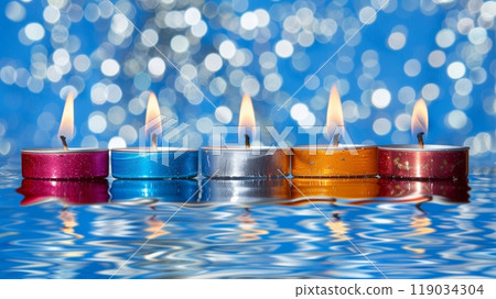 Five Colorful Floating Tea Light Candles on Water Surface with Abstract Blue Bokeh Background. 119034304