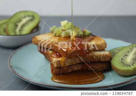 Honey for breakfast with fried toast and fruit. healthy snack healthy and tasty food concept Honey for breakfast with fried toast and fruit. healthy snack healthy and tasty food concept 119034787