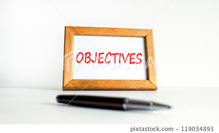 Objectives symbol. Concept word Objectives on beautiful wooden picture frame. Beautiful white background. Black pen. Business objectives concept. Copy space. Objectives symbol. Concept word Objectives on beautiful wooden picture frame. Beautiful white background. Black pen. Business objectives concept. Copy space. 119034893