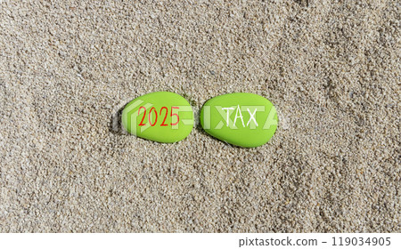 Planning 2025 tax new year symbol. Concept words 2025 Tax on beautiful green stones. Beautiful sand sea beach background. Business 2025 tax new year concept. Copy space. Planning 2025 tax new year symbol. Concept words 2025 Tax on beautiful green stones. Beautiful sand sea beach background. Business 2025 tax new year concept. Copy space. 119034905