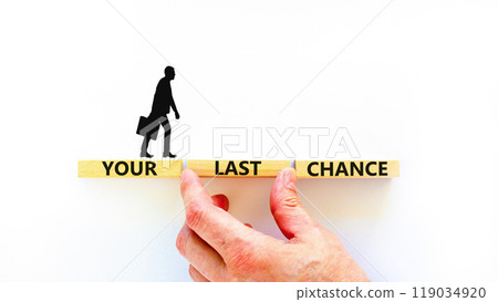 Time to your last chance symbol. Concept words Your last chance on wooden blocks on a beautiful white table white background. Businessman hand. Business and your last chance concept. Copy space. Time to your last chance symbol. Concept words Your last chance on wooden blocks on a beautiful white table white background. Businessman hand. Business and your last chance concept. Copy space. 119034920