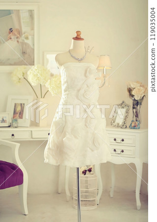 Stunning highly fashionable designer woman dress gown for party dress and sociable dress for modern socialite detail displayed on a mannequin in a luxurious background room 119035004