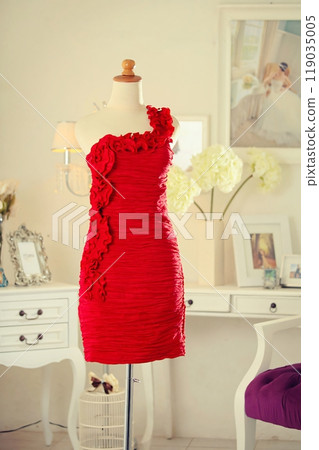 Stunning highly fashionable designer woman dress gown for party dress and sociable dress for modern socialite detail displayed on a mannequin in a luxurious background room 119035005