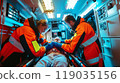 Two paramedics performing CPR on a patient inside a moving ambulance, bright interior lights, medical equipment all around 119035156
