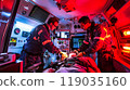 Two paramedics performing CPR on a patient inside a moving ambulance, bright interior lights, medical equipment all around 119035160