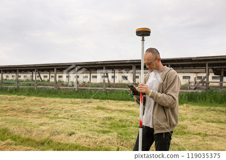 A surveyor works with a GNSS receiver 119035375