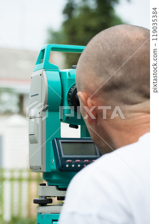 An engineer at work with a total station 119035384