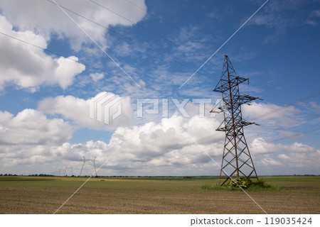 High-voltage power line tower in the field High-voltage power line tower in the field 119035424