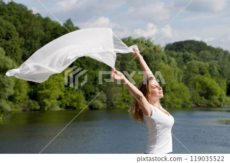 Young woman with white cloth, concept of ease and freedom Young woman with white cloth, concept of ease and freedom 119035522