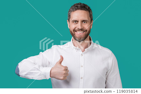 photo of mature businessman with stubble show thumb up. mature businessman isolated on blue photo of mature businessman with stubble show thumb up. mature businessman isolated on blue 119035814