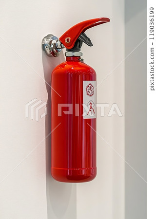 fire extinguisher on white wall, close up 119036199
