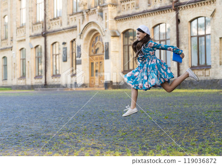 Teen girl jumping back to school. Knowledge day. Education in school. Girl student jump outdoor. September 1. Time to study. Knowledge and education. School education. Students life. Copy space Teen girl jumping back to school. Knowledge day. Education in school. Girl student jump outdoor. September 1. Time to study. Knowledge and education. School education. Students life. Copy space 119036872