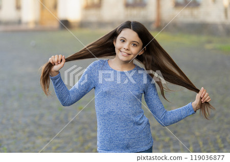 Teen girl with long hair outdoor. Autumn fashion girl. Trendy and stylish teenager girl smiling. Fall fashion style for teen. Complete outfit style. Girl portrait in casual sweater. Long strong hair Teen girl with long hair outdoor. Autumn fashion girl. Trendy and stylish teenager girl smiling. Fall fashion style for teen. Complete outfit style. Girl portrait in casual sweater. Long strong hair 119036877