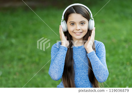School student lifestyle. Listen audio. Music lifestyle. Teen girl listen music in wireless headphones outdoor. Gen z lifestyle. Style of music. Stylish teen girl listen music. Copy space 119036879