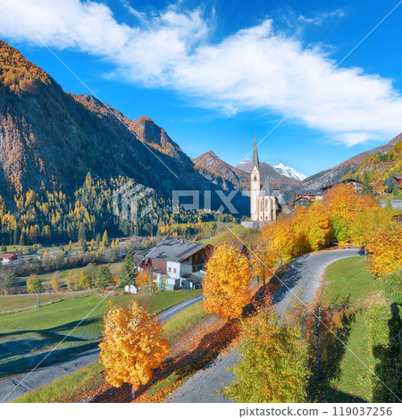 Amazing autumn landscape  at Heiligenblut with St Vincent Church near Grossglockner mount . 119037256