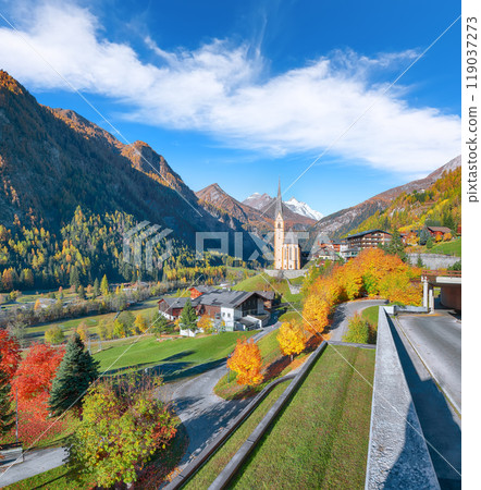 Picturesque autumn landscape  at Heiligenblut with St Vincent Church near Grossglockner mount . 119037273