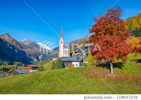 Picturesque autumn landscape  at Heiligenblut with St Vincent Church near Grossglockner mount . 119037278