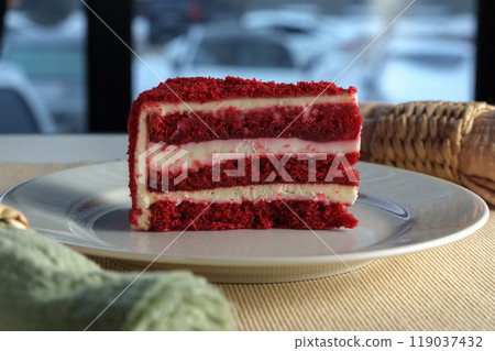 Savoring a delicious slice of red velvet cake in a cozy caf setting on a winter afternoon 119037432