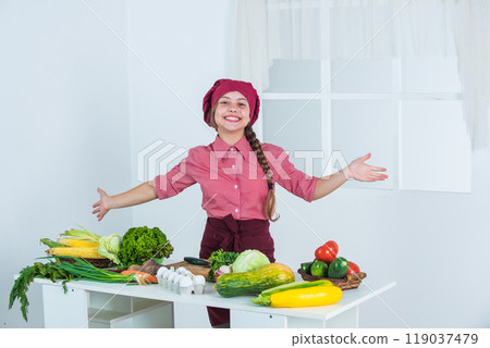 cheerful child prepares vegetable salad in kitchen, organic food cheerful child prepares vegetable salad in kitchen, organic food 119037479