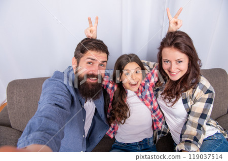 mom dad and daughter love relax together. adoption and charity. family day. friendship. mom dad and daughter love relax together. adoption and charity. family day. friendship. 119037514