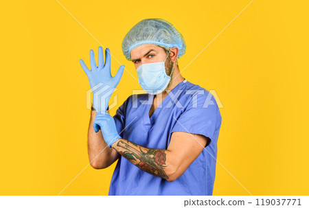 Coronavirus concept. Virus could mutate. Wearing mask. Protective functions. Protect people from virus. Beginning of virus outbreak. Man bearded doctor uniform yellow background. Type of virus 119037771