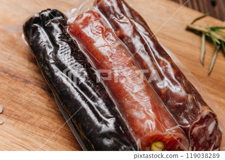 Assorted vacuum-packed salami with nuts and spices on board, charcuterie and gourmet dishes Assorted vacuum-packed salami with nuts and spices on board, charcuterie and gourmet dishes 119038289