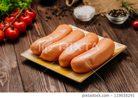 Four fresh sausages on plate, perfect for food photography, advertising, or culinary projects 119038291
