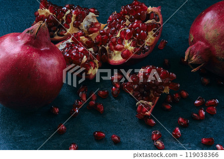 red ripe pomegranate fruits on dark background 119038366