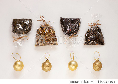 New year flat lay. Christmas tea gift box wrapped in kraft paper with pine tree cones.Mockup template. Winter holidays New year flat lay. Christmas tea gift box wrapped in kraft paper with pine tree cones.Mockup template. Winter holidays 119038403