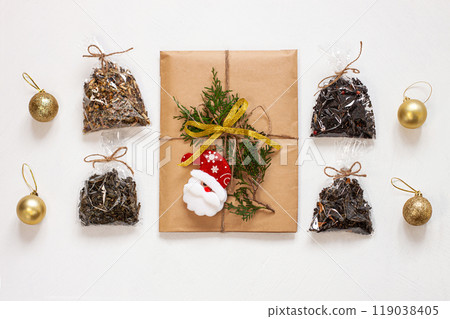 New year flat lay. Christmas tea gift box wrapped in kraft paper with pine tree cones.Mockup template. Winter holidays 119038405