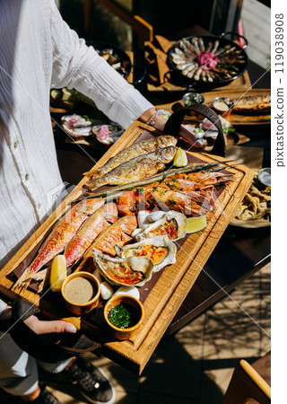 Seafood platter with shrimp, grilled fish, oysters. Menu design, food advertising, culinary projects Seafood platter with shrimp, grilled fish, oysters. Menu design, food advertising, culinary projects 119038908