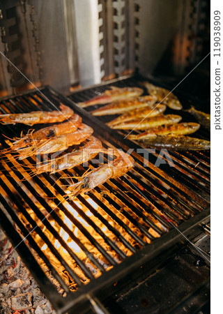 Grilled seafood on barbecue grill with fire, perfect for restaurant menus and food stock photography Grilled seafood on barbecue grill with fire, perfect for restaurant menus and food stock photography 119038909
